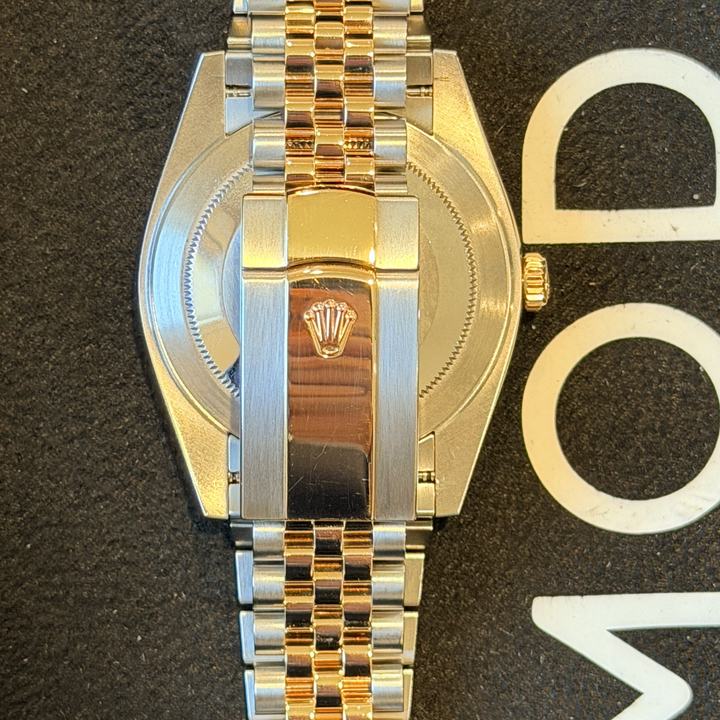Back of a steel and yellow gold Rolex on a Jubilee bracelet, five links across