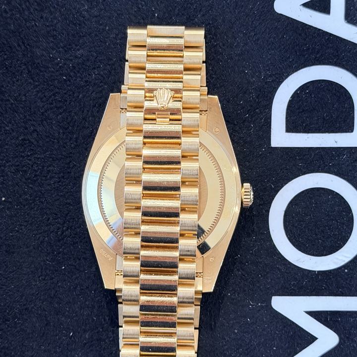 Back of a yellow gold Rolex on a President bracelet with rounded three-piece links