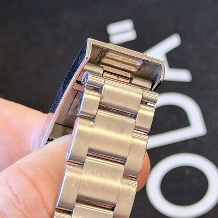 Rolex Submariner Glidelock clasp with the cover lifted, showing the bracelet end under the cover