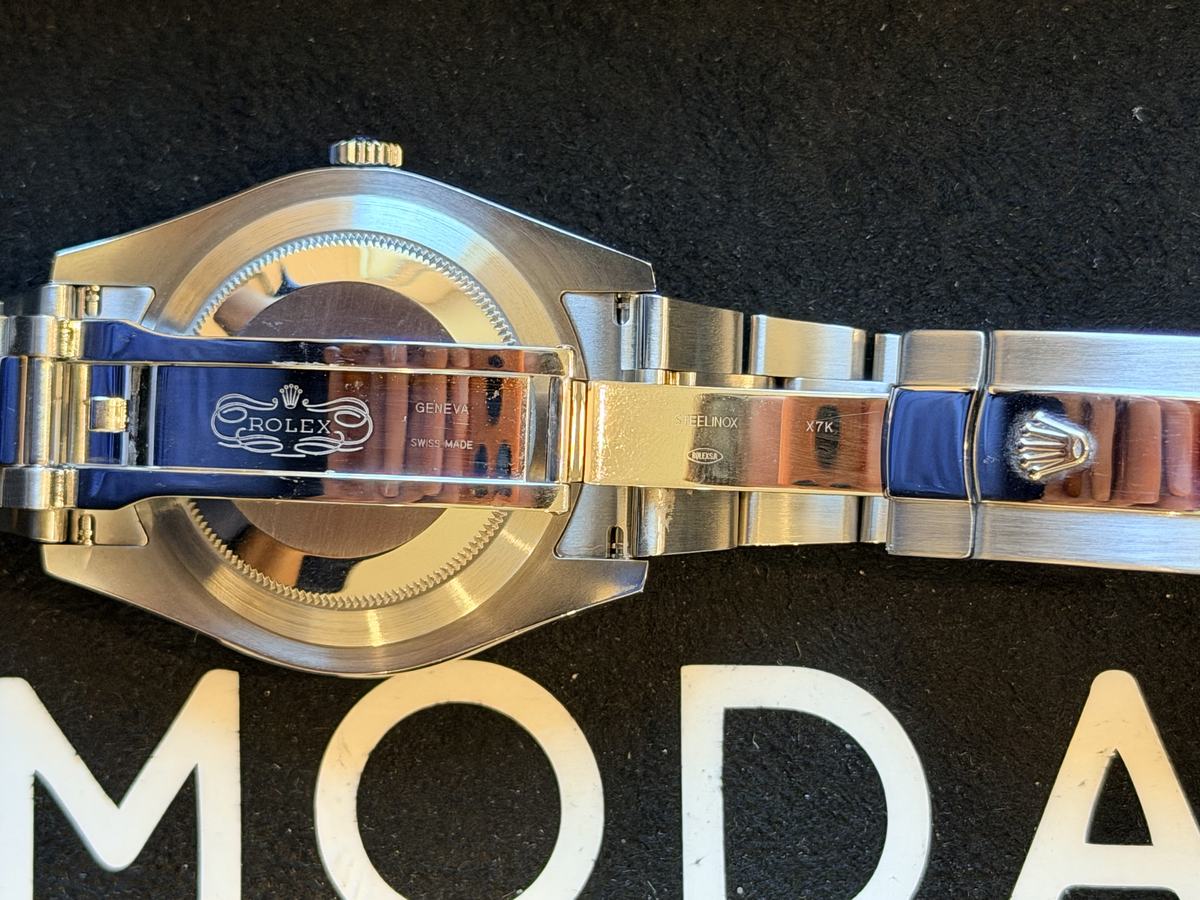 Open Rolex clasp showing the stamps Rolex, Geneva, Swiss Made, Steelinox and the code X7K